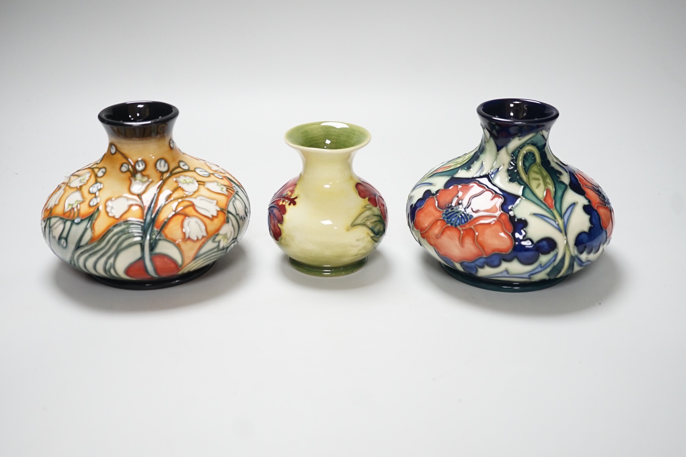 Three Moorcroft vases, in Poppy, Hibiscus and Tulip designs, tallest 10.5 cm, one boxed